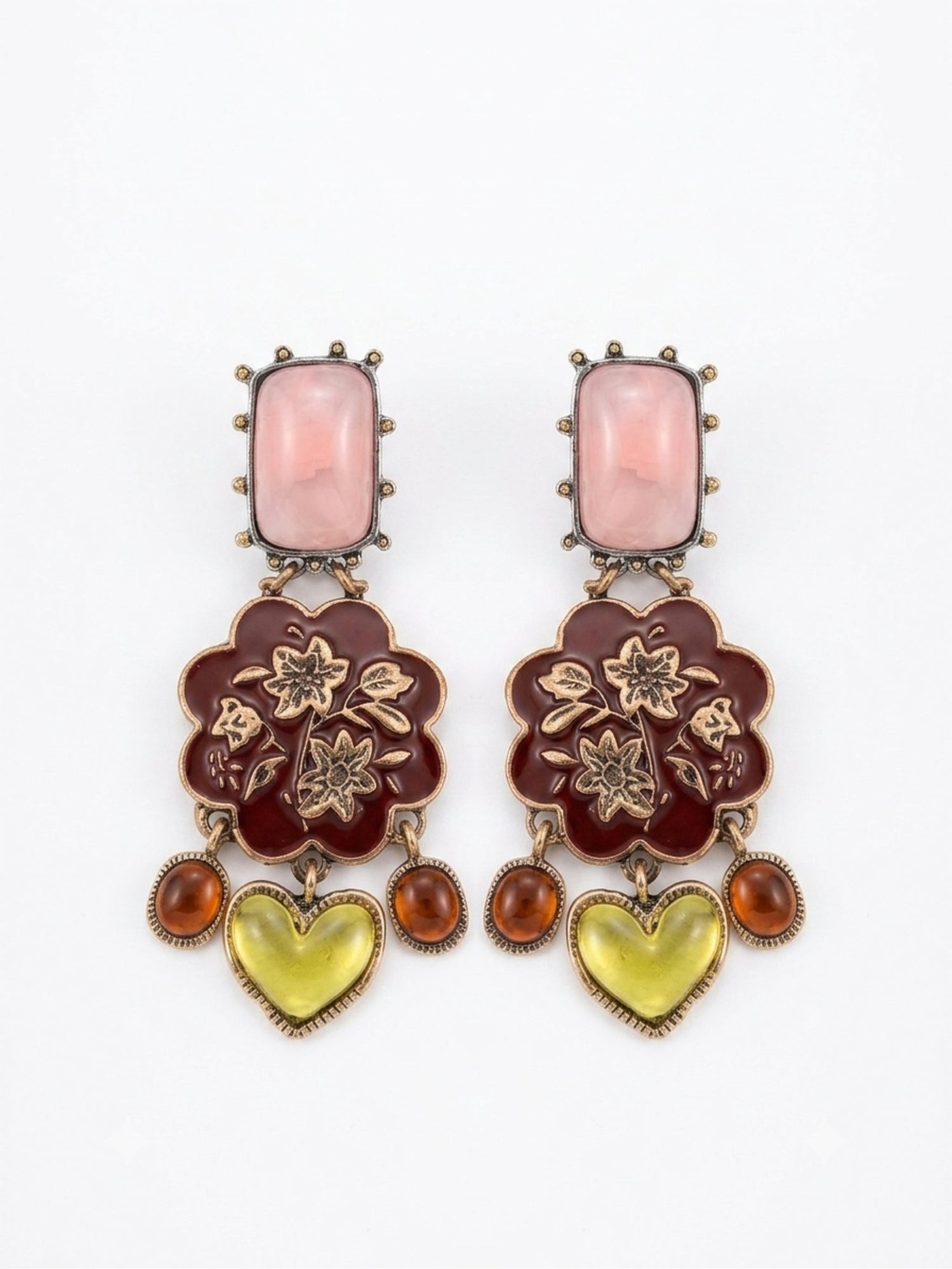 A pair of ornate drop earrings featuring a rectangular pink stone, a dark red floral enamel motif with gold-tone floral details, and dangling amber and yellow heart-shaped stones, set against a plain white background.