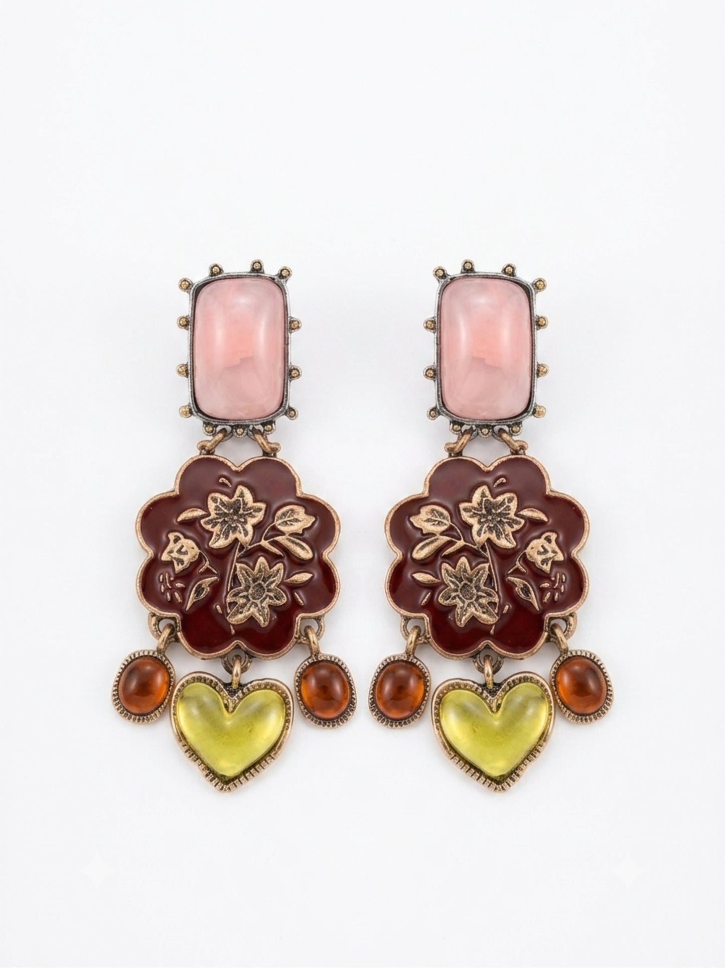 A pair of ornate drop earrings featuring a rectangular pink stone, a dark red floral enamel motif with gold-tone floral details, and dangling amber and yellow heart-shaped stones, set against a plain white background.