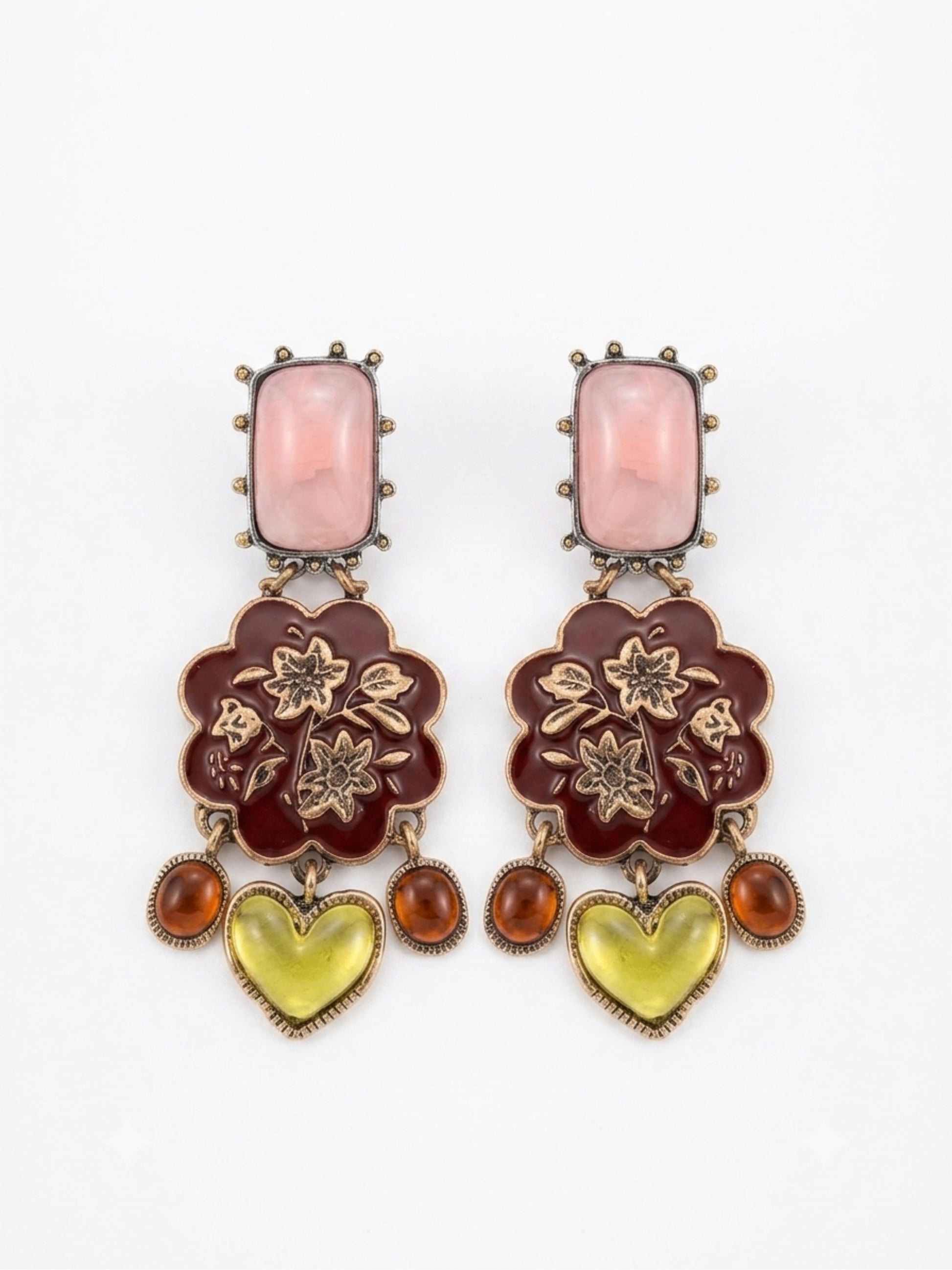 A pair of ornate drop earrings featuring a rectangular pink stone, a dark red floral enamel motif with gold-tone floral details, and dangling amber and yellow heart-shaped stones, set against a plain white background.