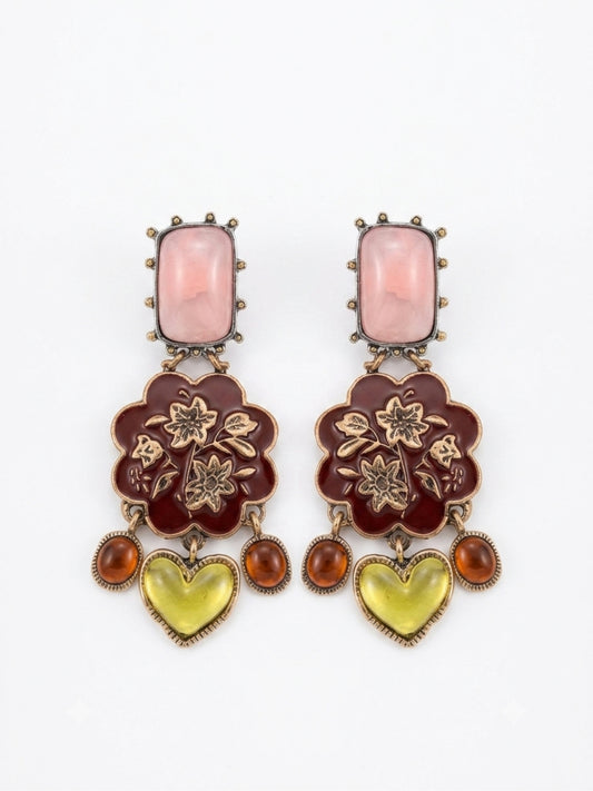 A pair of ornate drop earrings featuring a rectangular pink stone, a dark red floral enamel motif with gold-tone floral details, and dangling amber and yellow heart-shaped stones, set against a plain white background.